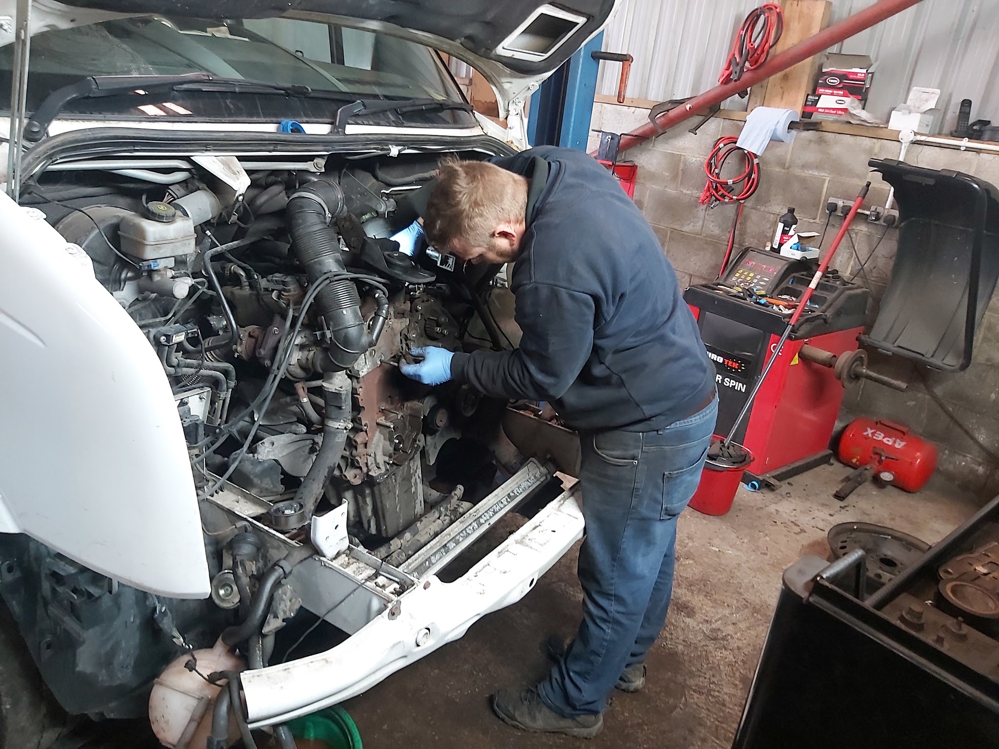 One of our mechanics working in an engine bay